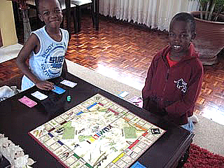 Boys playing on the first soap stone game board.